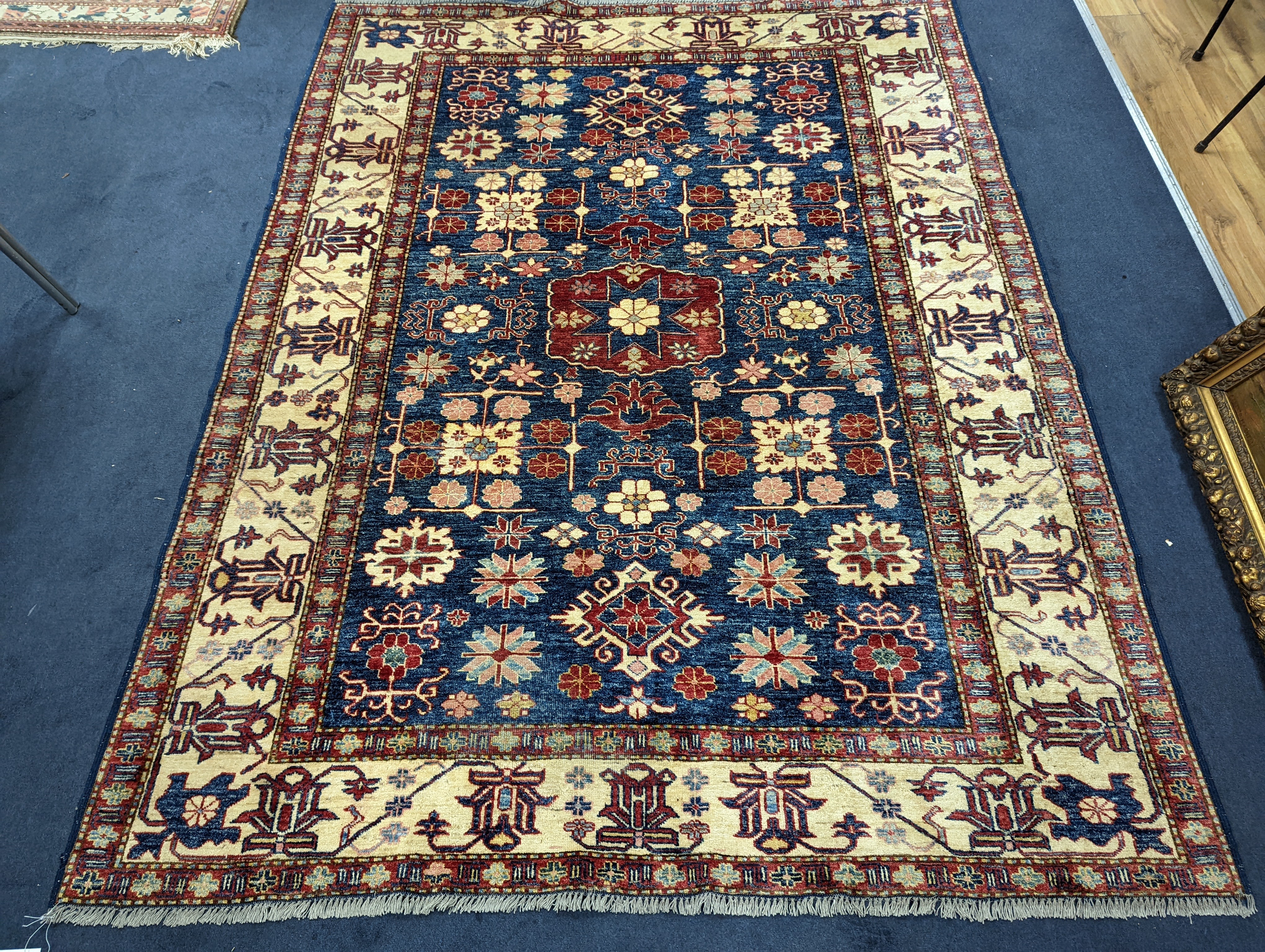 A Kazak blue ground carpet, 242 x 186cm